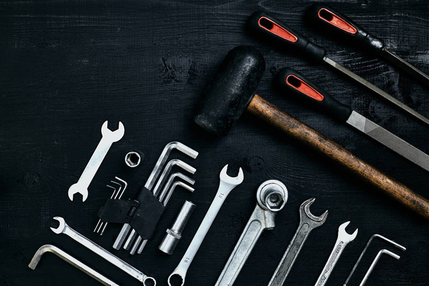 Flat lay of set of tools for car repairing such as wrenches on black wooden background. Top view. - Photo, Image
