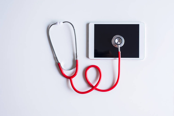 Stethoscope red color on tablet and white background,Healthcare and medical concept - Fotoğraf, Görsel