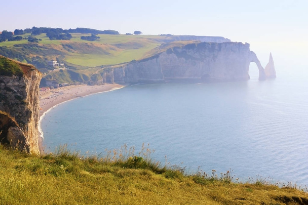 French city of Etretat on the shore of the ocean on a bright sun - Photo, Image