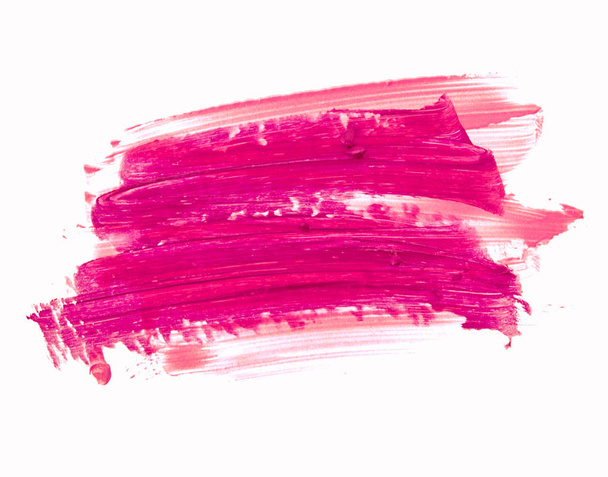 Pink lipstick smeared on white. Cosmetic product. - Zdjęcie, obraz