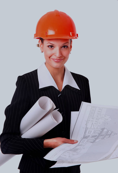 Female architect holding blueprints. - Фото, изображение