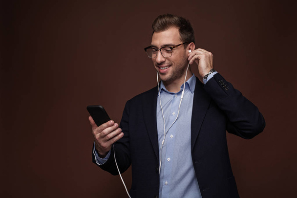Cheerful male hearing song in headset - Фото, изображение