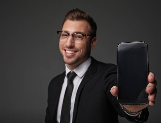 Glad man holding phone in arm - Photo, Image