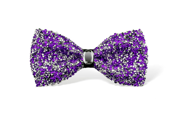 Glamorous purple sparkling glitter decorated bow tie with jewel in the centre, trendy fashion accessory isolated on white background - Photo, Image