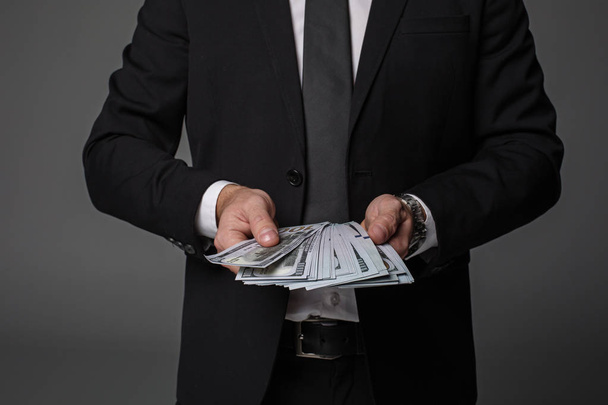 Businessman arms holding bundle of money - Foto, Bild