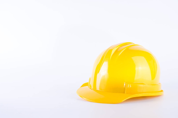 Yellow safety helmet on white background. Hard hat isolated on white. Safety equipment concept. Worker and Industrial theme. - Photo, Image