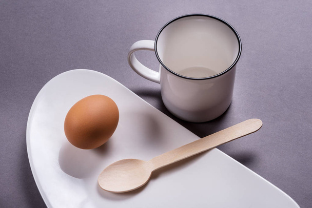 Simple breakfast, boiled egg on white porcelain - Photo, Image