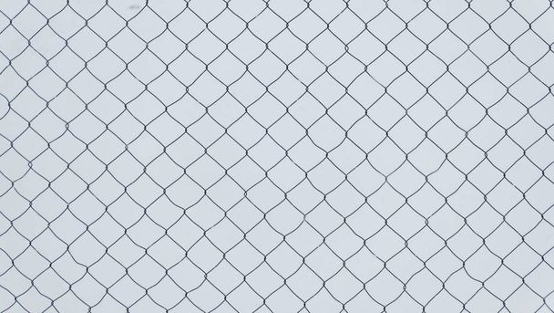 The texture of a chain-link fence on a white background. - Photo, Image
