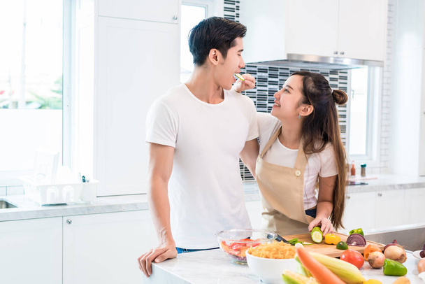 Asian Lovers feeding fruit and food to each other, Couple and Family concept. Sweet honeymoon and Holidays theme. Holiday and Indoor interior - Fotografie, Obrázek