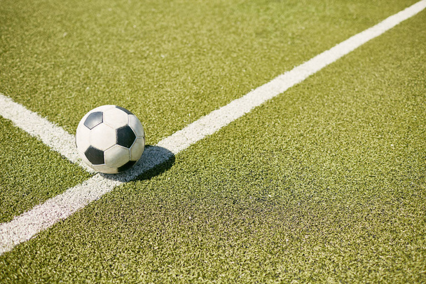 High angle closeup of ball lying on green football field, copy space - Photo, Image