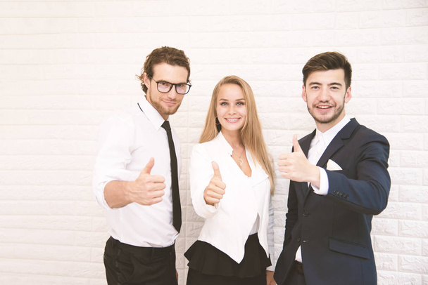 Team workers thumbs up for success in business in front of wall at cafe, Business and success concept, Teammate and Cooperation, Soft tone pinterest and instragram like process. - 写真・画像