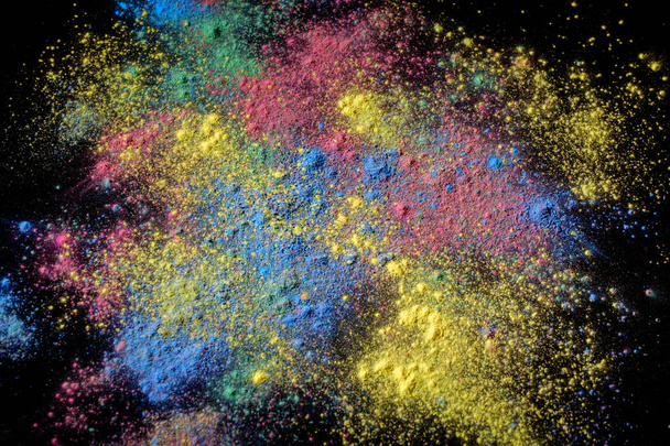Holi paint background. Color powder explosion on black. - Photo, image