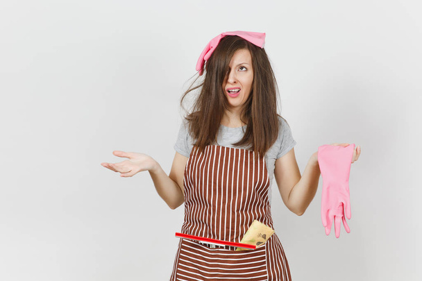 Young fun crazy dizzy loony wild screaming housewife tousled hair in striped apron squeegee cleaning rag in pocket isolated on white background. Mad woman and pink gloves. Copy space for advertisement - Photo, Image