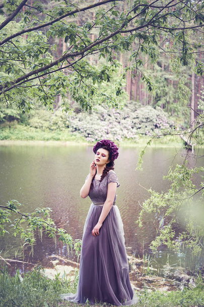 girl in dress in rhododendron garden - Fotó, kép