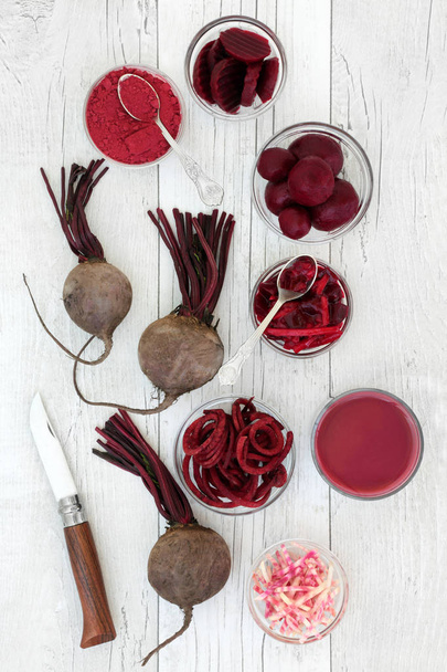 Beetroot health and super food with smoothie juice drink, fresh, powder, sliced, pickled and shredded beetroots on rustic wood background. Has medicinal properties and contains anthocyanins, vitamins and antioxidants. - Photo, Image