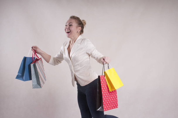 woman with jacket in shopping bags studio - 写真・画像