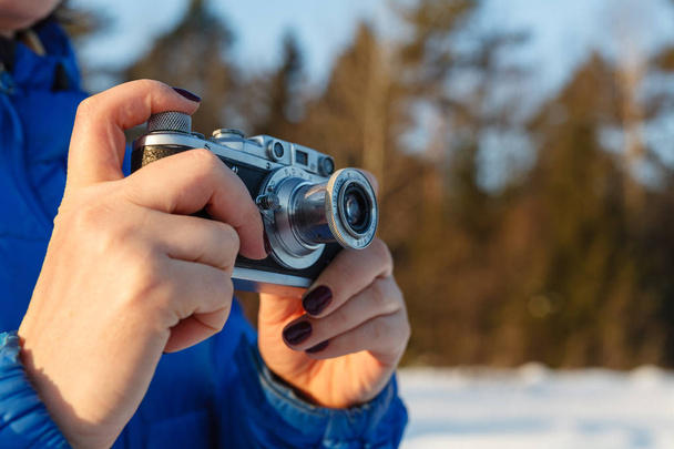 Vintage camera in hand, outdoor winter with sky - Φωτογραφία, εικόνα