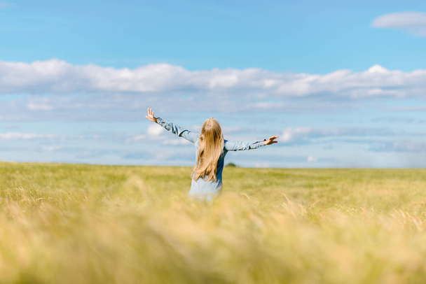 the happy girl runs with wheat across the field - Valokuva, kuva