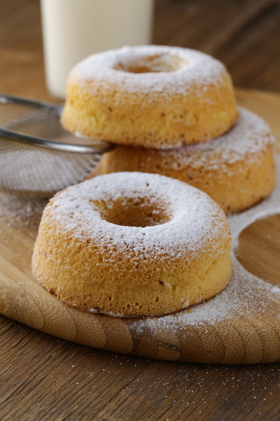 Fresh donuts sprinkled with powdered sugar - Photo, Image