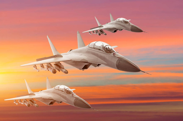Combattants militaires jet trois avions de groupe à grande vitesse, volant haut dans le ciel coucher de soleil
. - Photo, image