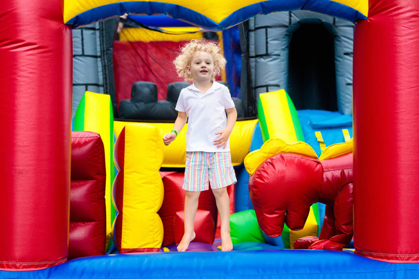Child jumping on playground trampoline. Kids jump. - Photo, Image