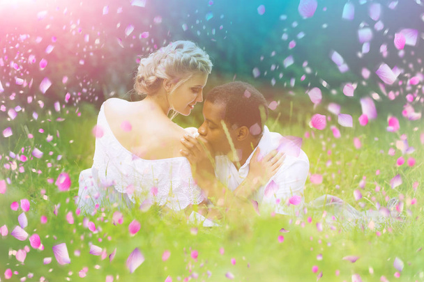 young couple in blooming meadow. Couple having fun in blooming park - Foto, Imagen