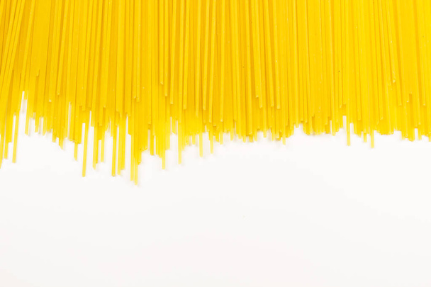Long yellow pasta isolated on white background close up macro. - Photo, Image