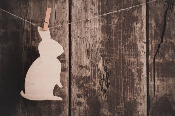 Easter wooden bunny on wooden background  - Фото, зображення