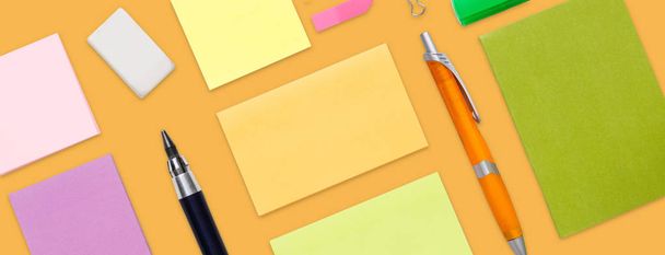 Top view of colorful office and school stationery, isolated on yellow - Photo, Image