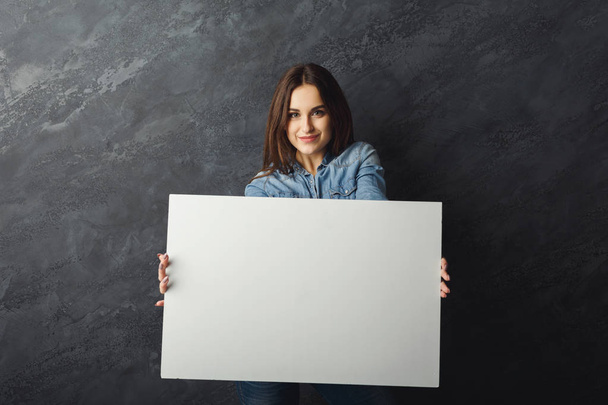 Young woman holding blank white banner - Photo, Image