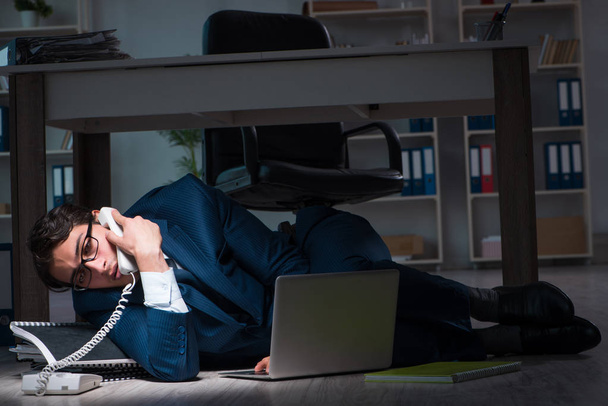 Businessman working overtime long hours late in office - Photo, Image