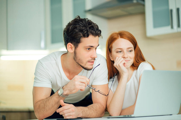 couple with laptop spending time together at home - Photo, Image