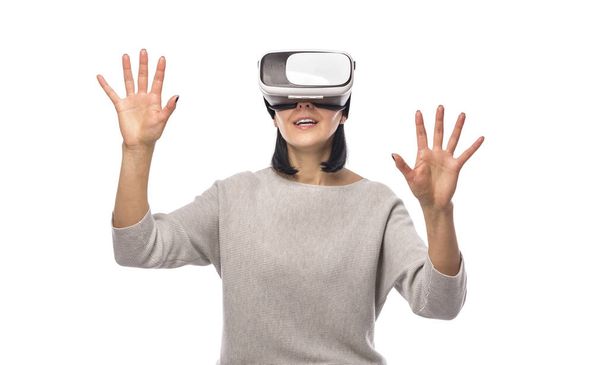 Young woman in a virtual reality helmet on a white. - Fotó, kép