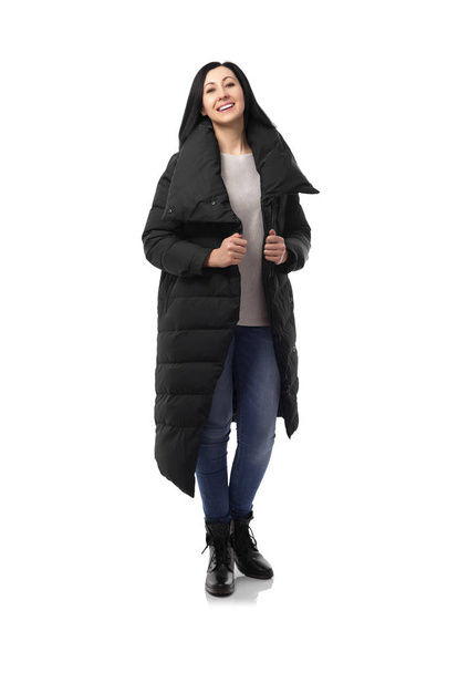 Attractive woman in a down jacket isolated on white. - Фото, изображение