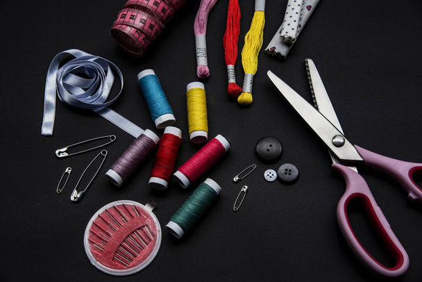 Sewing materials on the black background, close up - Photo, Image