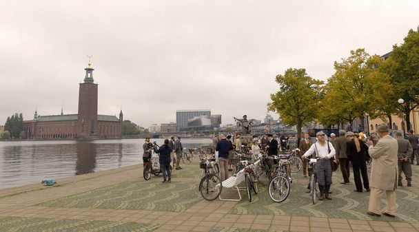 ESTOCOLMO - 23 DE SEPTIEMBRE DE 2017: Mucha gente vestida con ropa de tweed anticuada sosteniendo bicicletas frente al Ayuntamiento de Estocolmo en el evento Bike in Tweed 23 de septiembre de 2017 en Estocolmo, Suecia
 - Foto, imagen