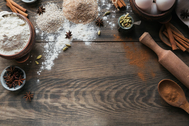 Ingredients for cooking bread or cookies: oat bran, flour, eggs, spices on rustic wooden background. Healthy food concept. Food background. Top view with copy space for text - Foto, Bild