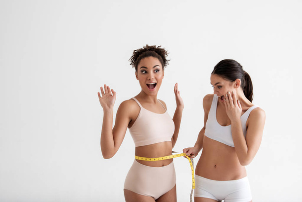 Pleased girls achieving a goal in weight loss - Fotografie, Obrázek
