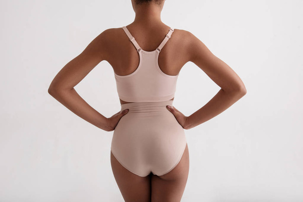 Neat female body standing in slinky underwear - Foto, Imagen