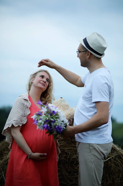 Pregnant girl with big belly and young man outdoor - Fotografie, Obrázek
