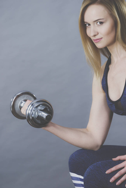 Fit woman lifting dumbbells weights - 写真・画像