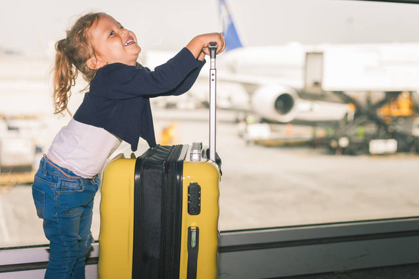 Happy baby carries your luggage at the airport terminal. - 写真・画像