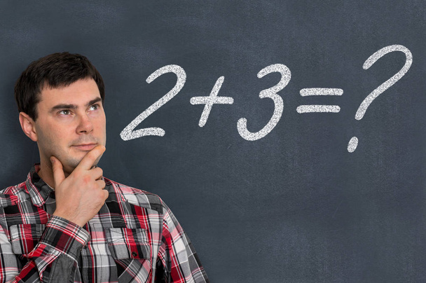 Man is counting a mathematical task on blackboard - Photo, Image