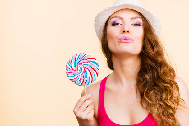 Woman holds colorful lollipop candy in hand - Photo, image