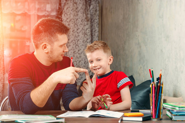 The father helps his son to do homework - Zdjęcie, obraz