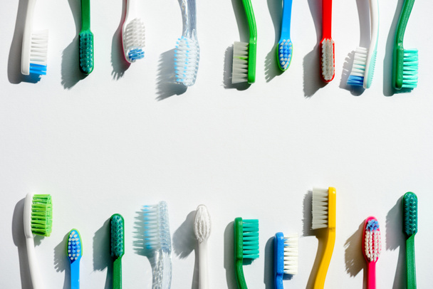 diferentes cepillos de dientes de colores, en blanco con espacio de copia
 - Foto, Imagen
