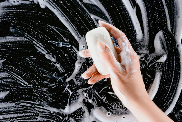 cropped view of woman holding soap with white foam - Zdjęcie, obraz