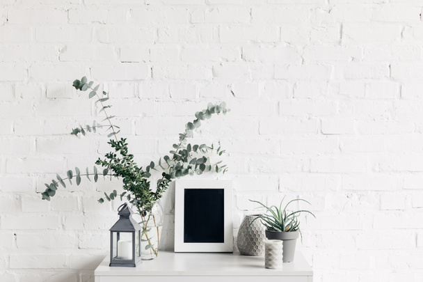 houseplants with blank small chalkboard in front of white brick wall, mockup concept - Photo, Image
