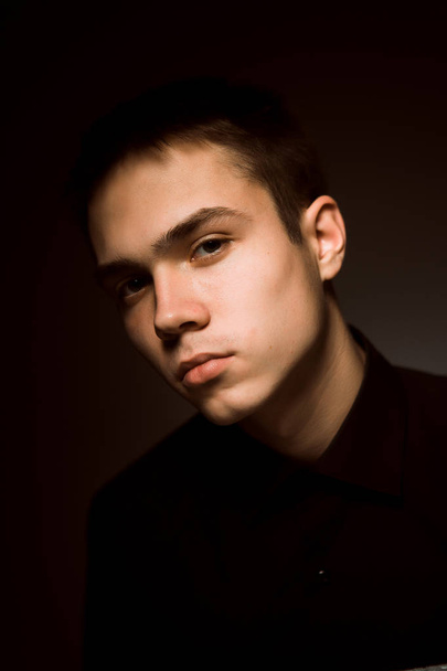 young guy on a dark studio background - Foto, immagini