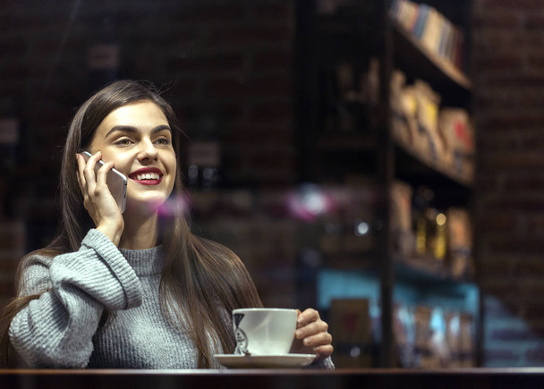 Girl Talking by Phone in Cafe - Фото, изображение